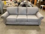 ASHLEY FURNITURE Stone Grey Suede-Like Roll Arm Sofa with Nailhead Trim