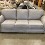 ASHLEY FURNITURE Stone Grey Suede-Like Roll Arm Sofa with Nailhead Trim